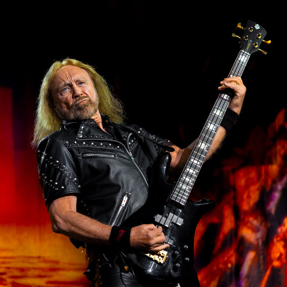 Bassist Ian Hill of Judas Priest performing live on stage.