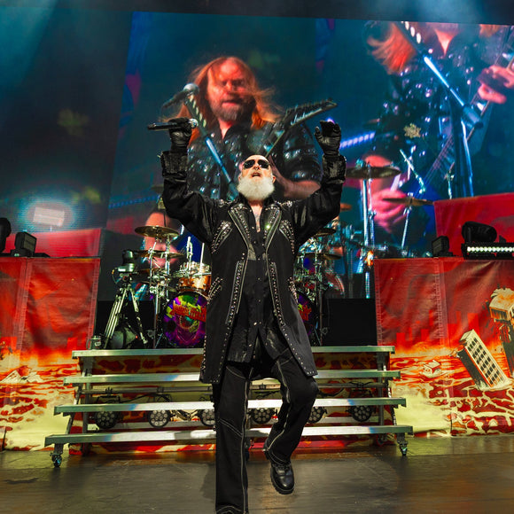 Judas Priest performing live on stage.